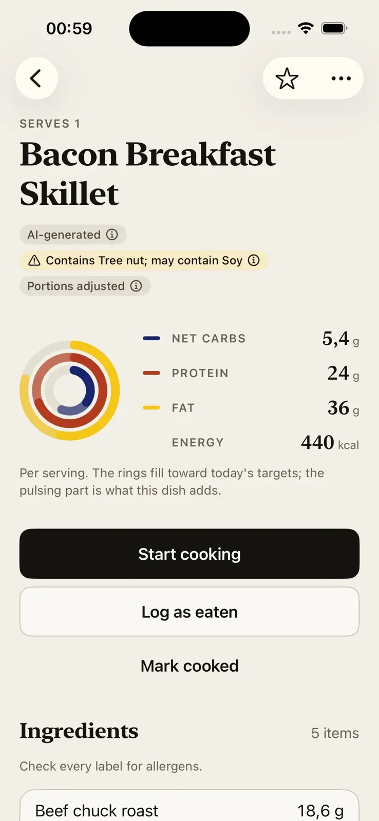A recipe, Bacon Breakfast Skillet, serving one. Three tags under the name: AI-generated, a yellow warning that it contains tree nut and may contain soy, and portions adjusted. The rings sit beside 5.4 grams of net carbs, 24 grams of protein, 36 grams of fat and 440 kilocalories, over a line saying the rings fill toward today's targets and the pulsing part is what this dish adds. Then three actions, Start cooking, Log as eaten and Mark cooked, and the head of a five item ingredient list with a reminder to check every label for allergens.
