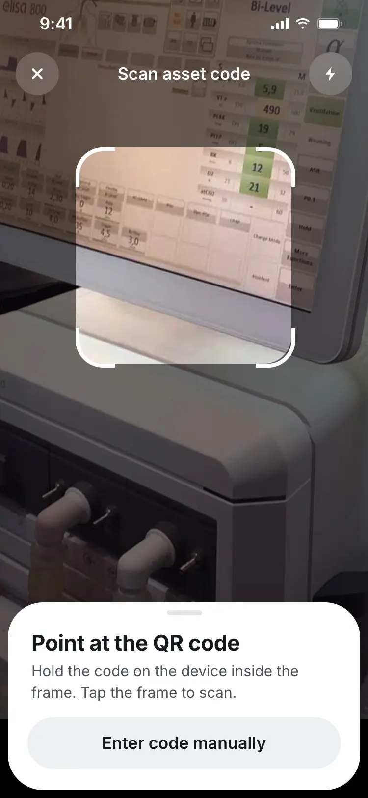 The scanner screen prompting the nurse to point the camera at a device's QR code.